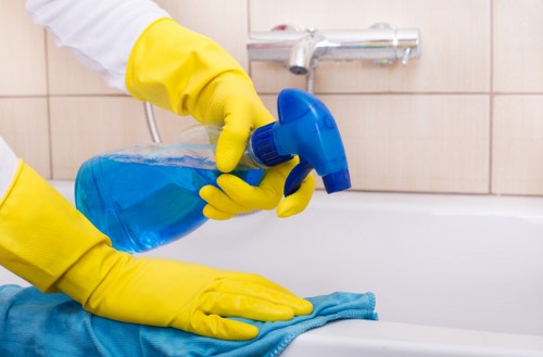 Spot cleaning a sofa stain with a microfiber cloth